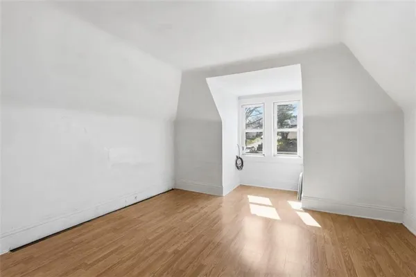 a view of a room with wooden floor and white walls
