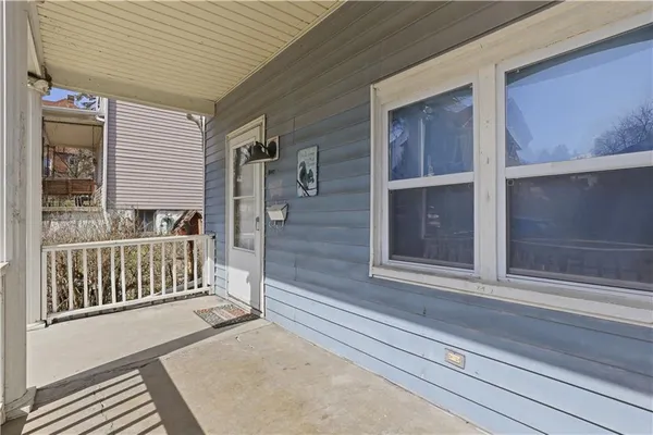 a view of a porch with a door and a window