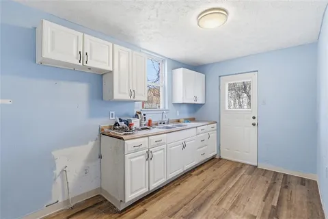 a kitchen with sink cabinets and window