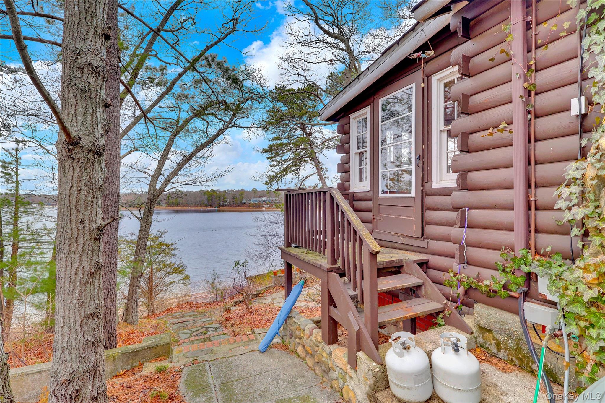 97 Lakeside Trail Ridge, NY 11961 - Photo 4 of 25 west side of home with sidewalk/steps to lake