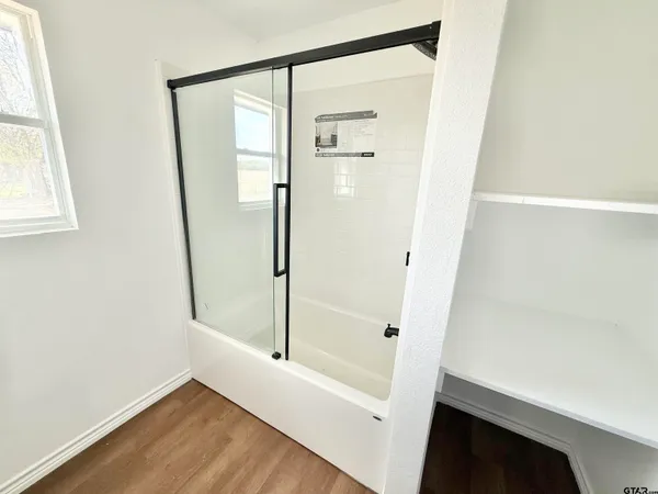 a bathroom with a glass shower door