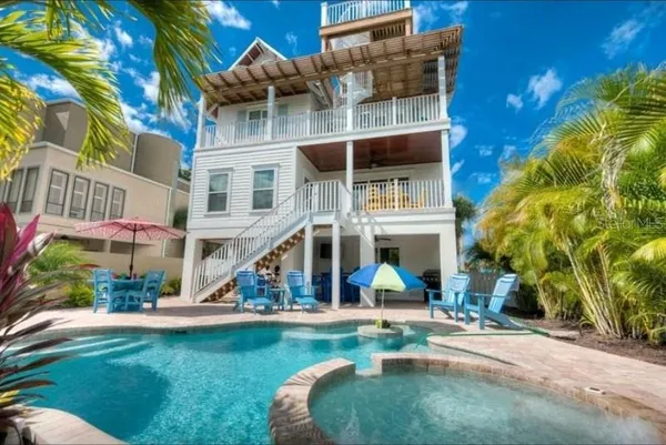 a view of a house with a yard porch and sitting area