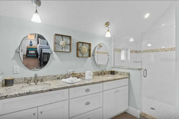 a bathroom with a sink a vanity and a mirror