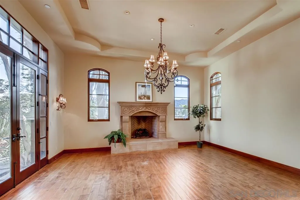 14160 Bryce Point Poway, CA 92064 - Photo 5 of 25 a view of a livingroom with a fireplace chandelier and wooden floor