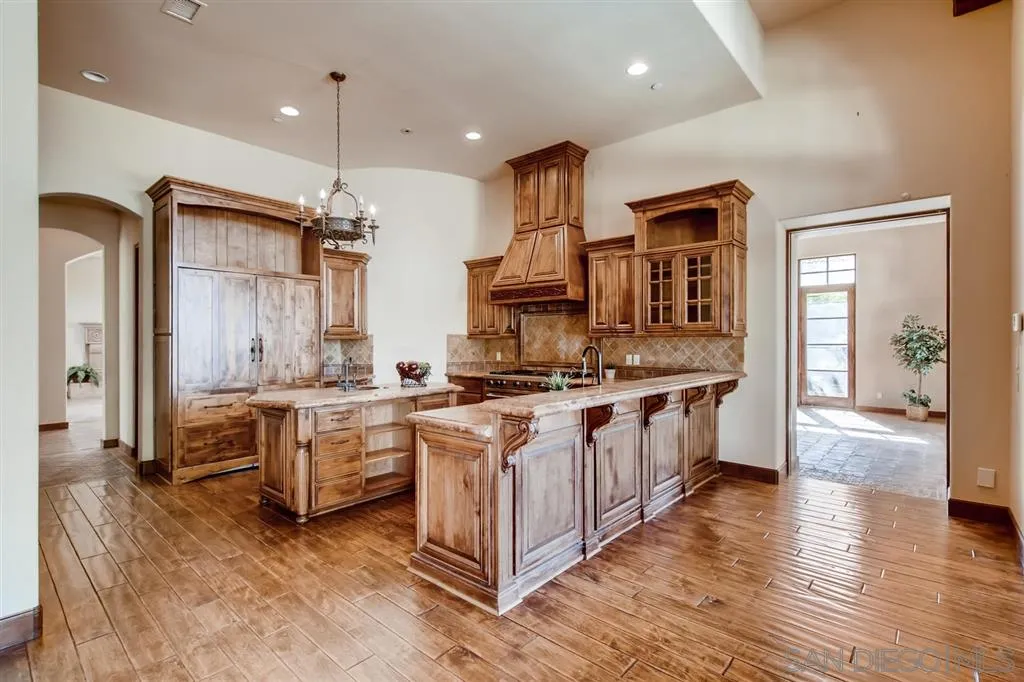 14160 Bryce Point Poway, CA 92064 - Photo 7 of 25 a large kitchen with stainless steel appliances a stove a sink dishwasher and a refrigerator