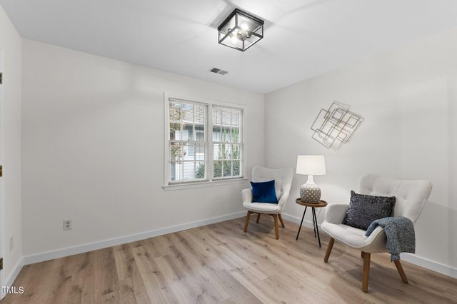 a view of a room with furniture and wooden floor