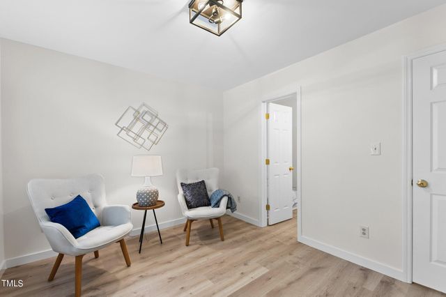 a view of a room with furniture and wooden floor