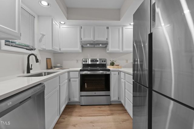 a kitchen with a stove and a refrigerator