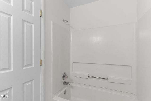 a bathroom with a tub sink and vanity