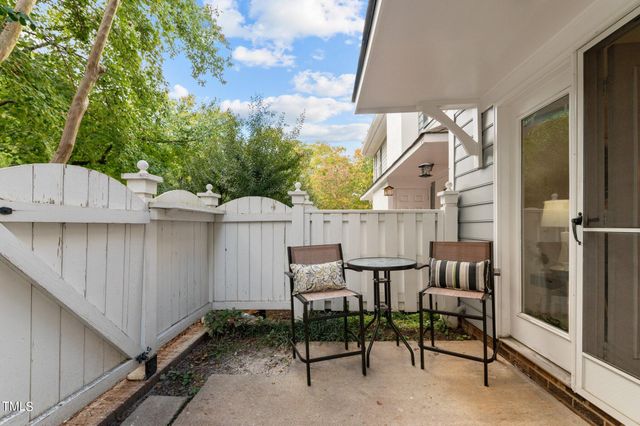 a view of backyard with outdoor seating and plants