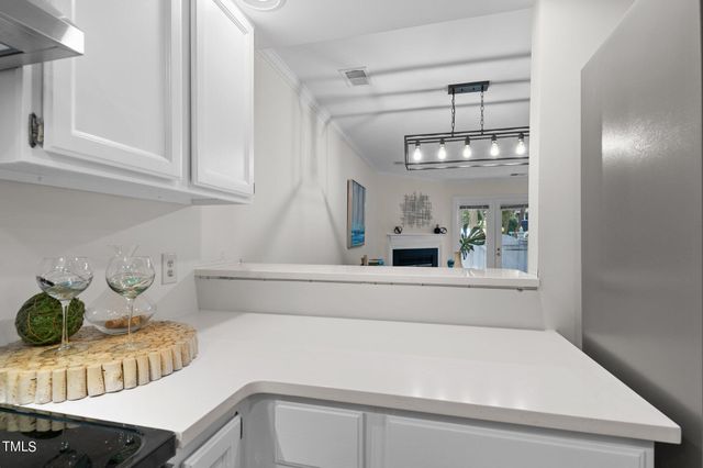 a kitchen with a refrigerator and a table