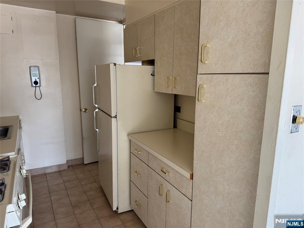 2 Horizon Road, Unit G2 Fort Lee, NJ 07024 - Photo 12 of 18 a kitchen with a refrigerator and cabinets