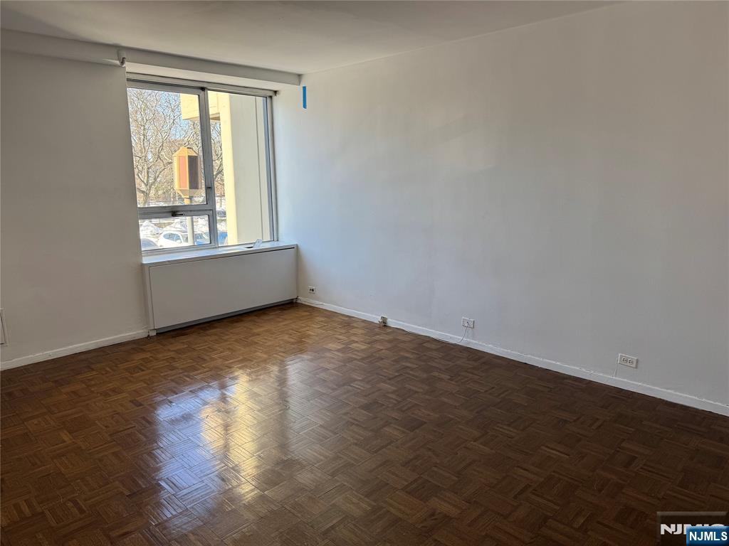 2 Horizon Road, Unit G2 Fort Lee, NJ 07024 - Photo 10 of 18 an empty room with wooden floor and windows