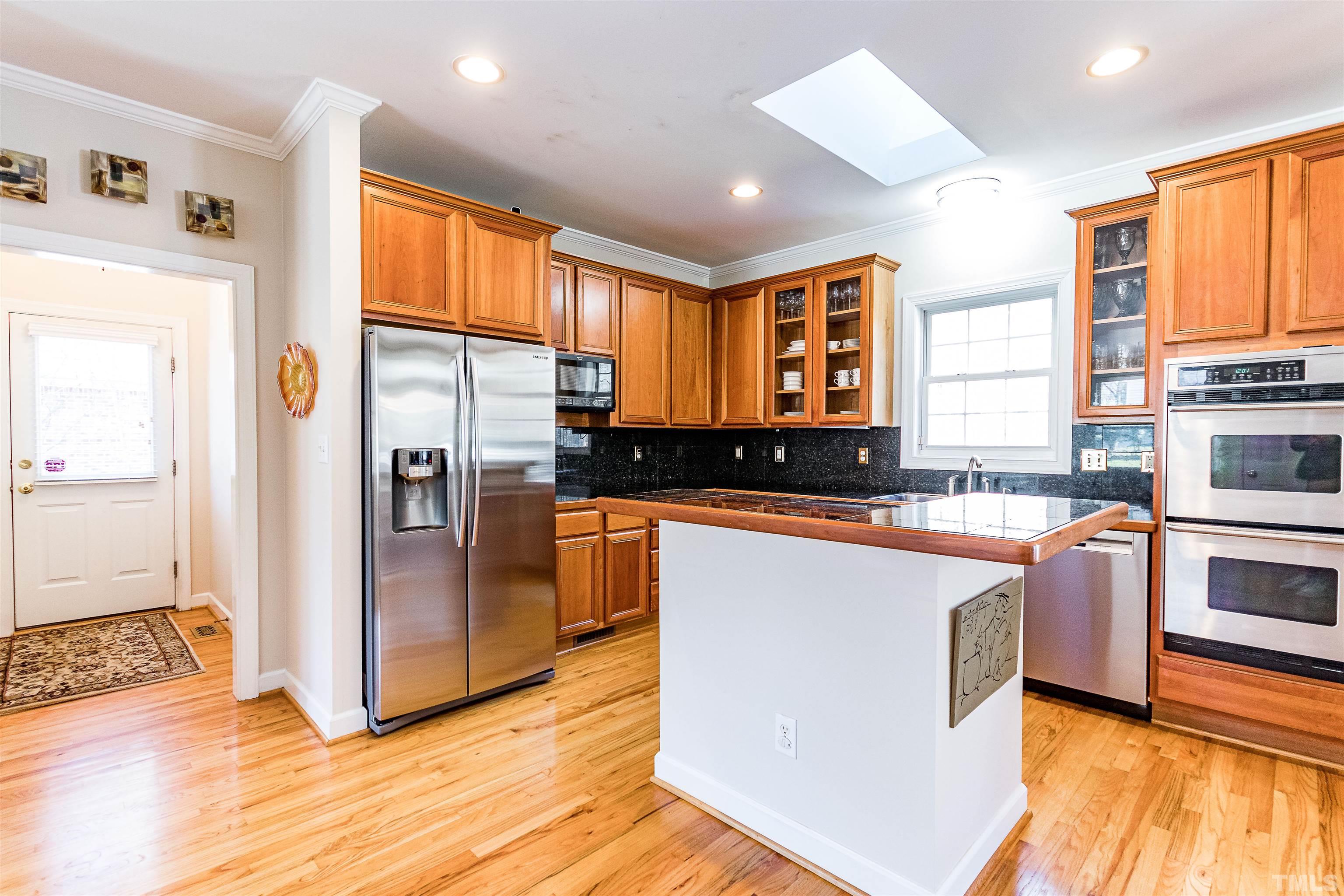 3324 Edgemont Drive Raleigh, NC 27612 - Photo 11 of 29 a kitchen with stainless steel appliances granite countertop a refrigerator a stove and a sink