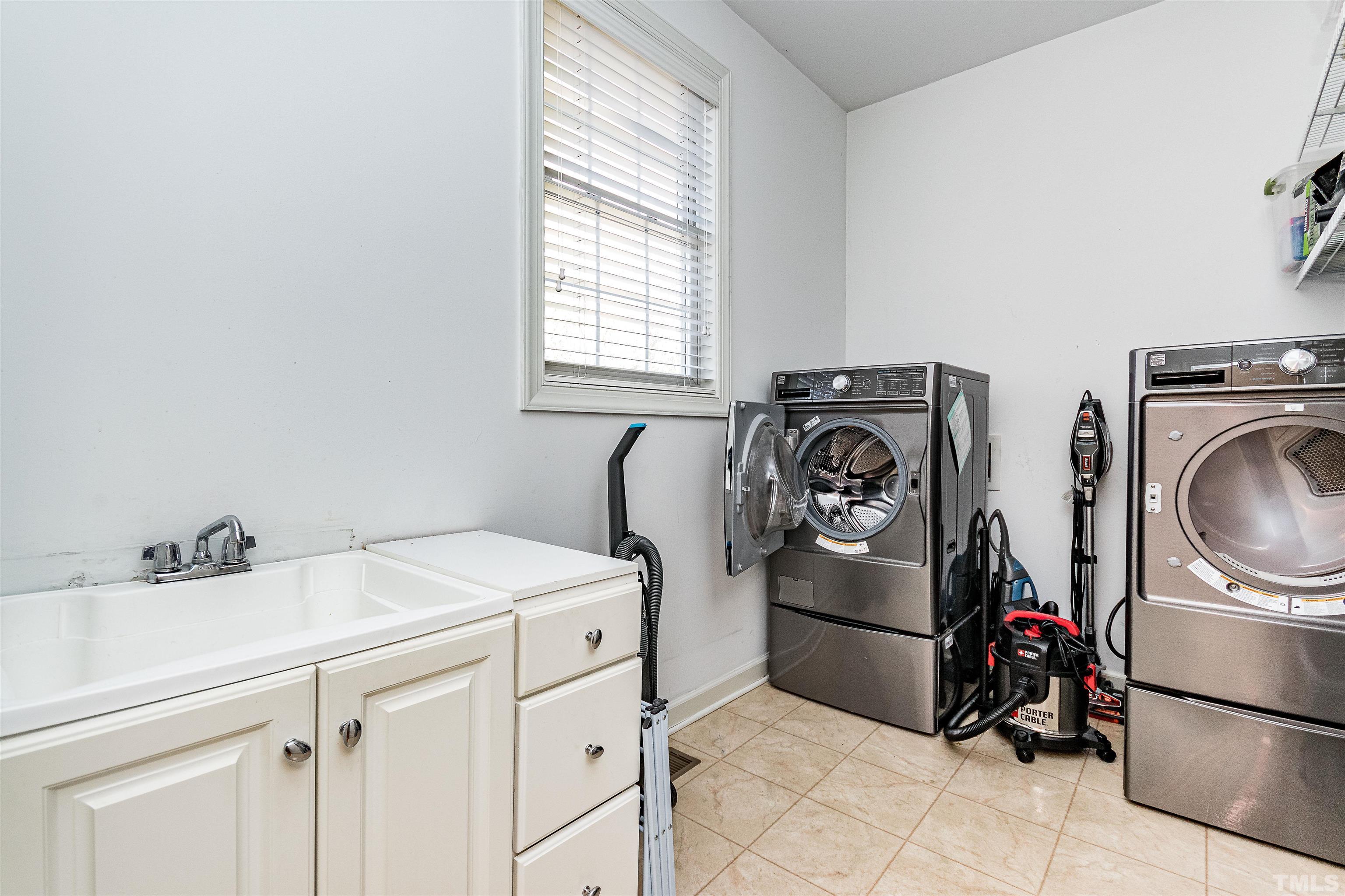 3324 Edgemont Drive Raleigh, NC 27612 - Photo 17 of 29 a utility room with dryer washer and a window
