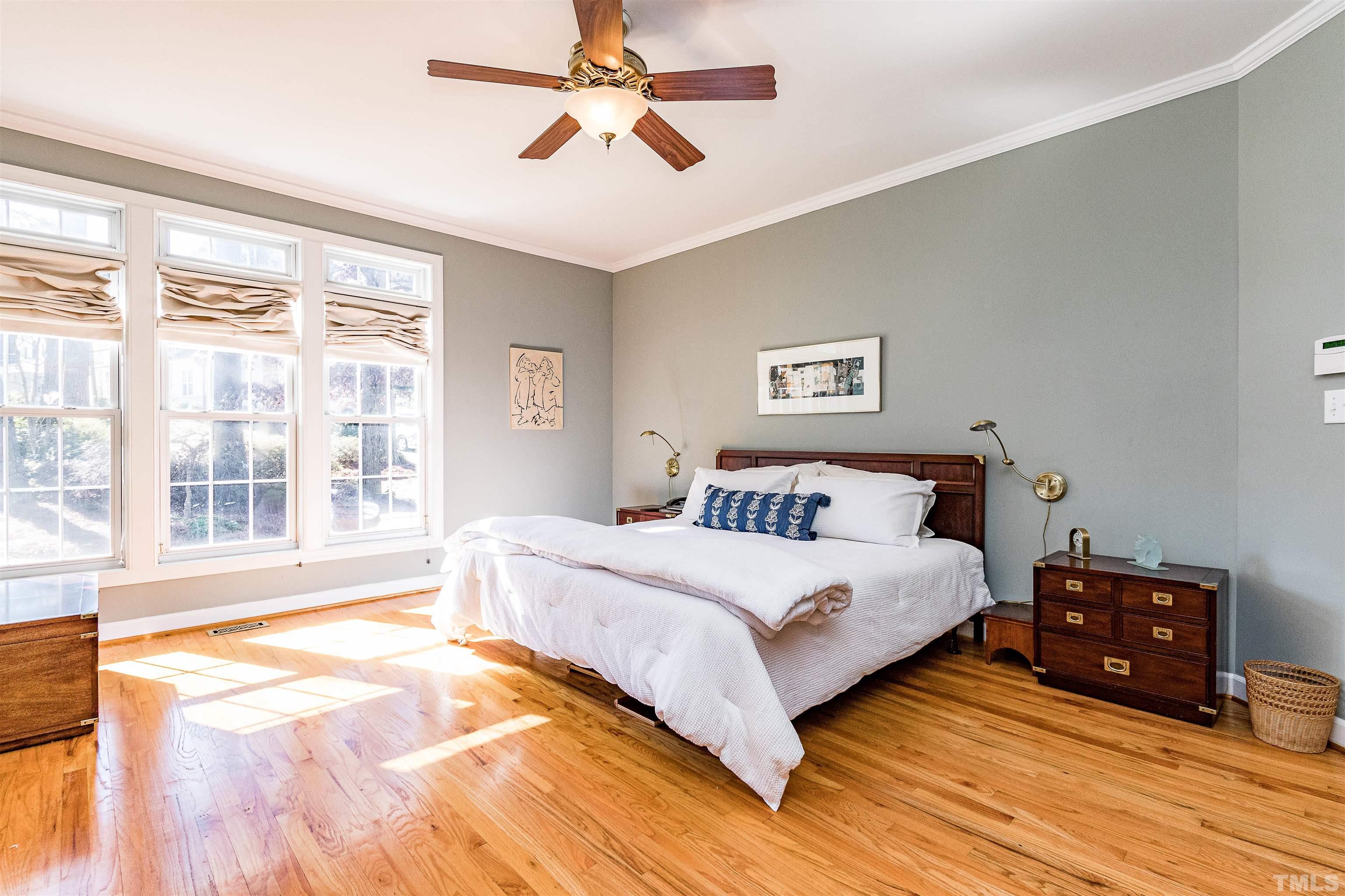 3324 Edgemont Drive Raleigh, NC 27612 - Photo 18 of 29 a spacious bedroom with a large bed and a large window