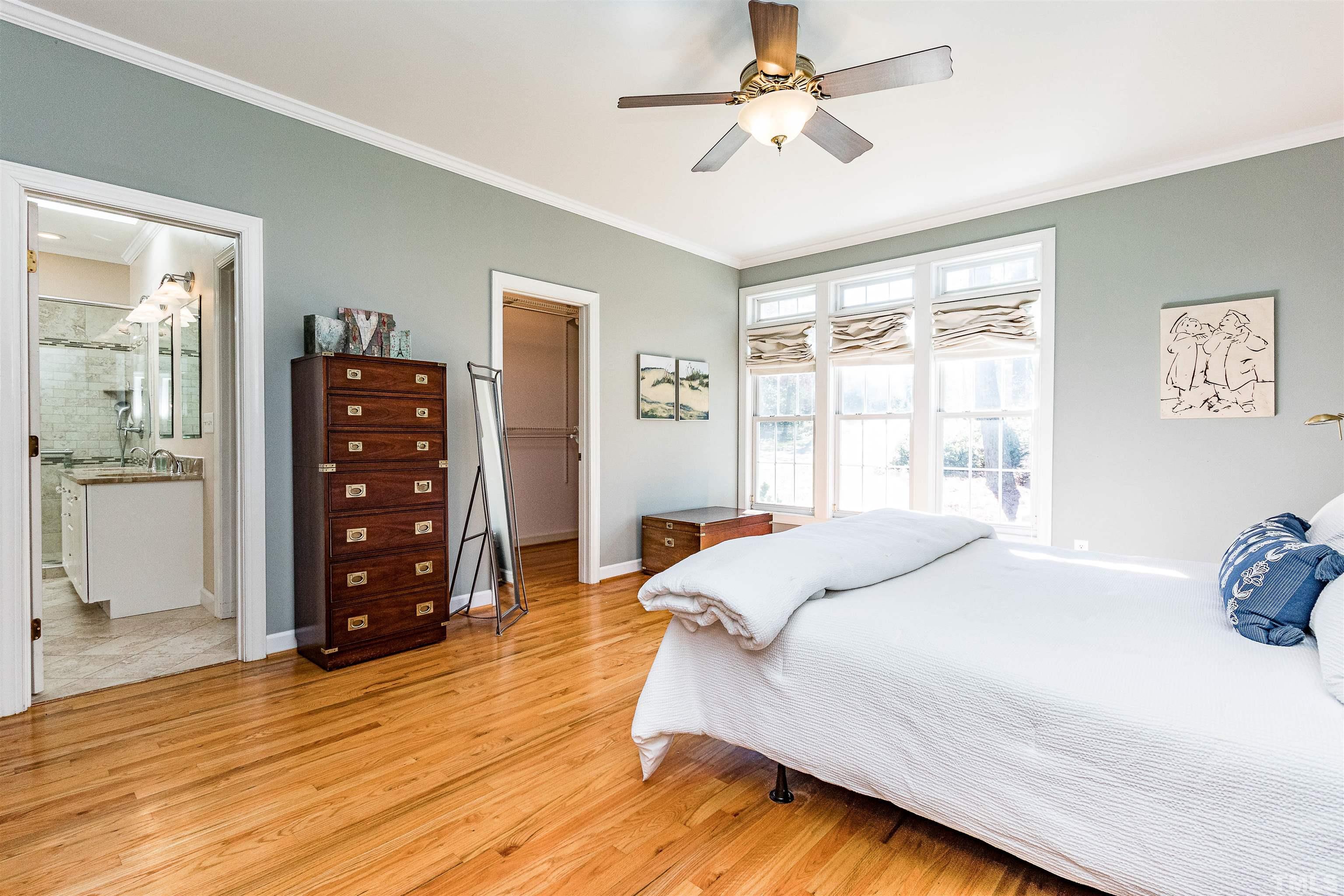 3324 Edgemont Drive Raleigh, NC 27612 - Photo 19 of 29 a bedroom with a bed a dresser and a window