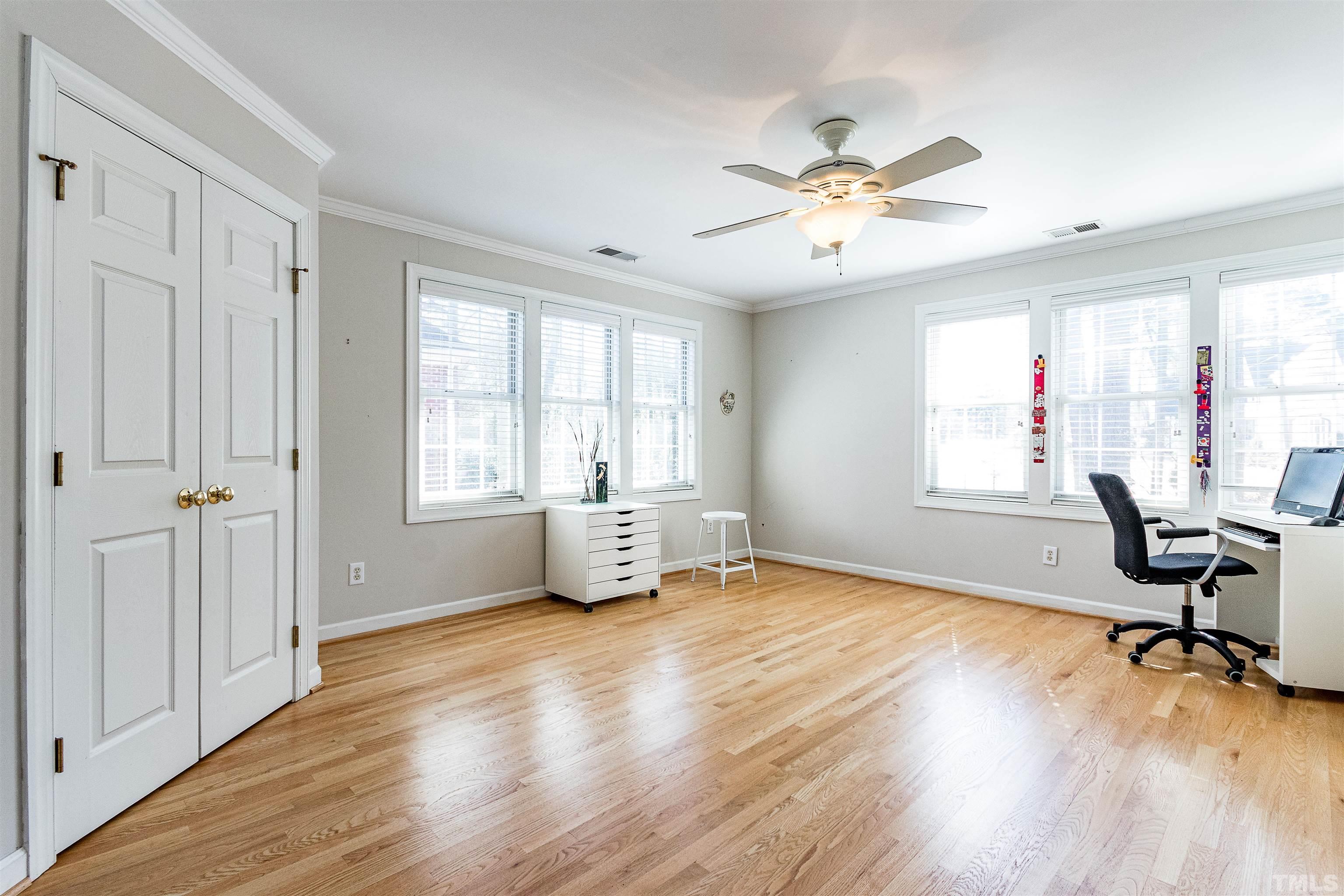 3324 Edgemont Drive Raleigh, NC 27612 - Photo 24 of 29 a view of an empty room with a window and wooden floor