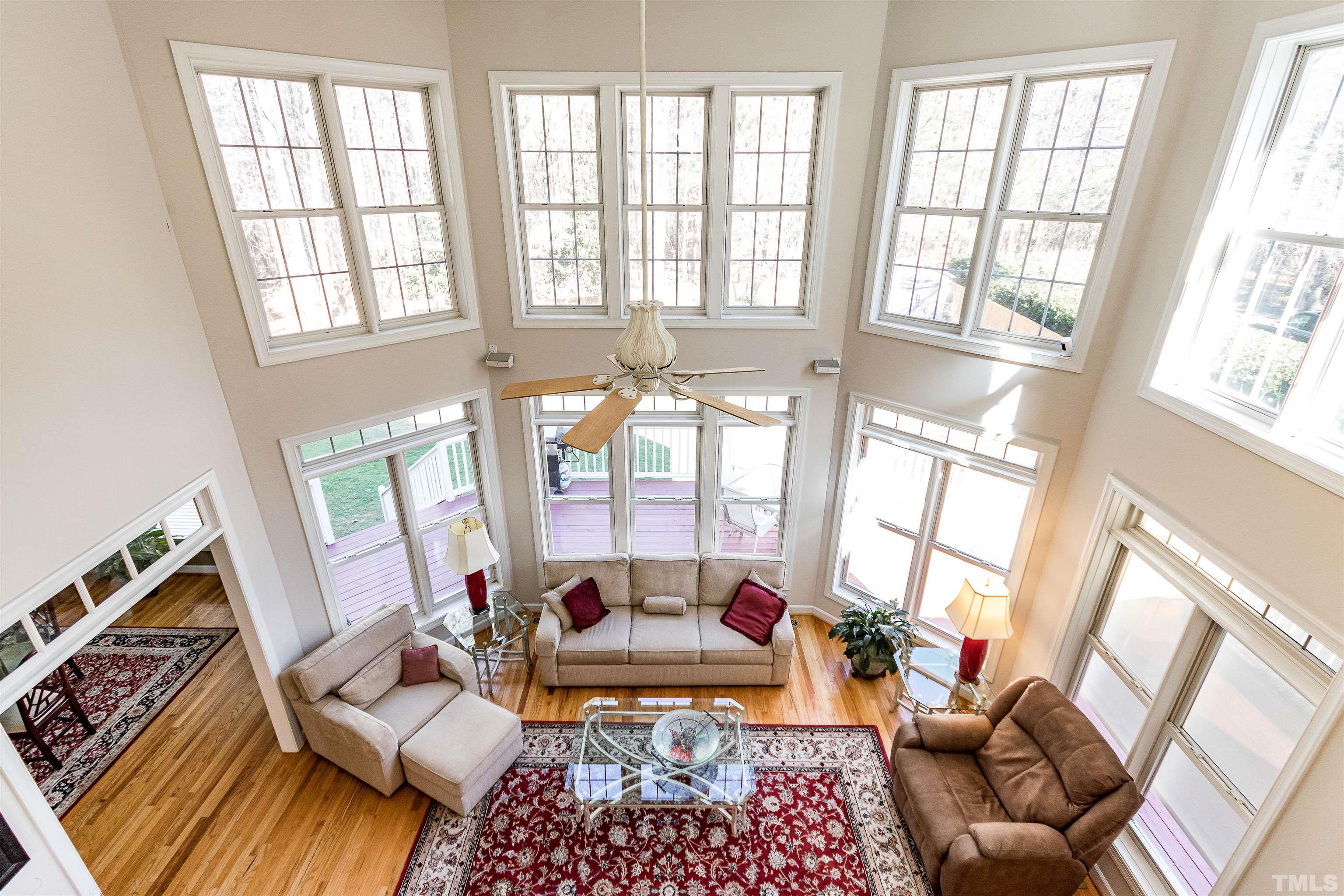 3324 Edgemont Drive Raleigh, NC 27612 - Photo 25 of 29 a living room with furniture and a floor to ceiling window