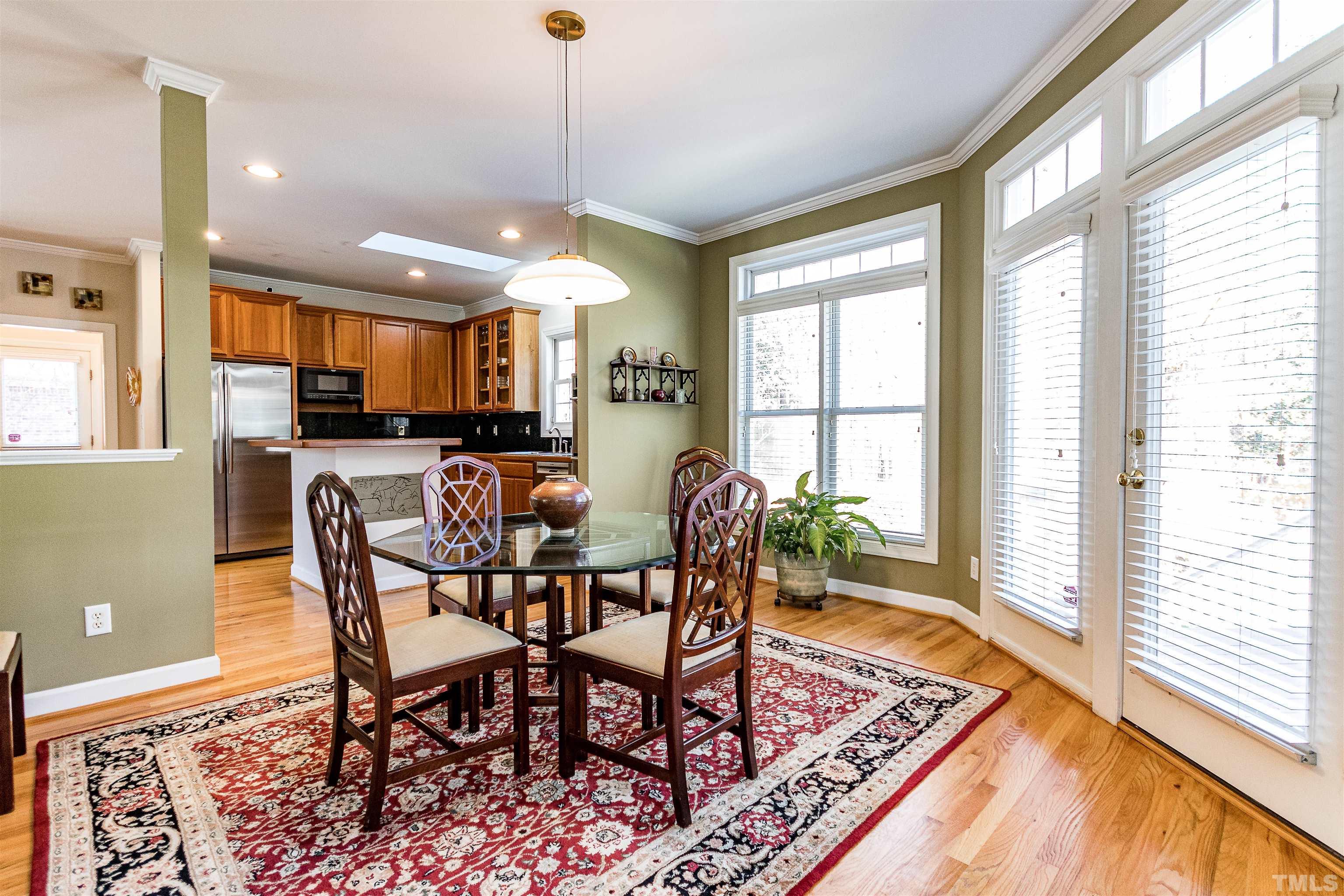 3324 Edgemont Drive Raleigh, NC 27612 - Photo 9 of 29 a view of a dining room with furniture window and wooden floor