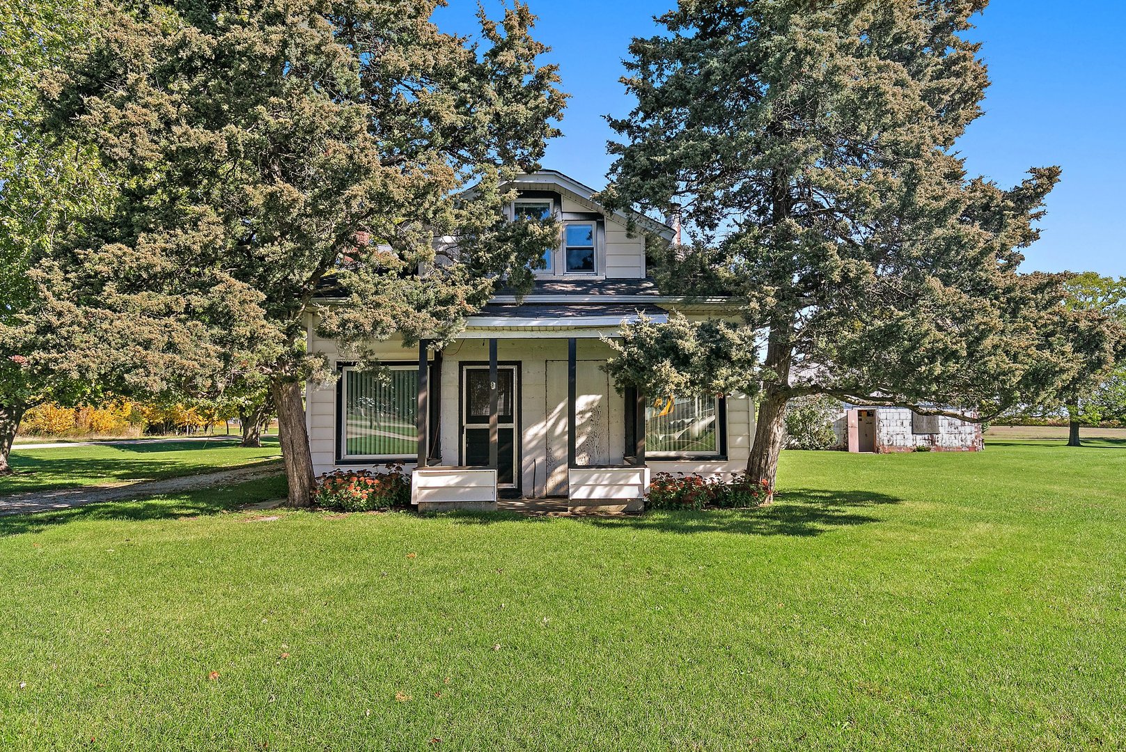 10178 Preserve Road Waterman, IL 60556 - Photo 1 of 18 a front view of a house with garden and trees
