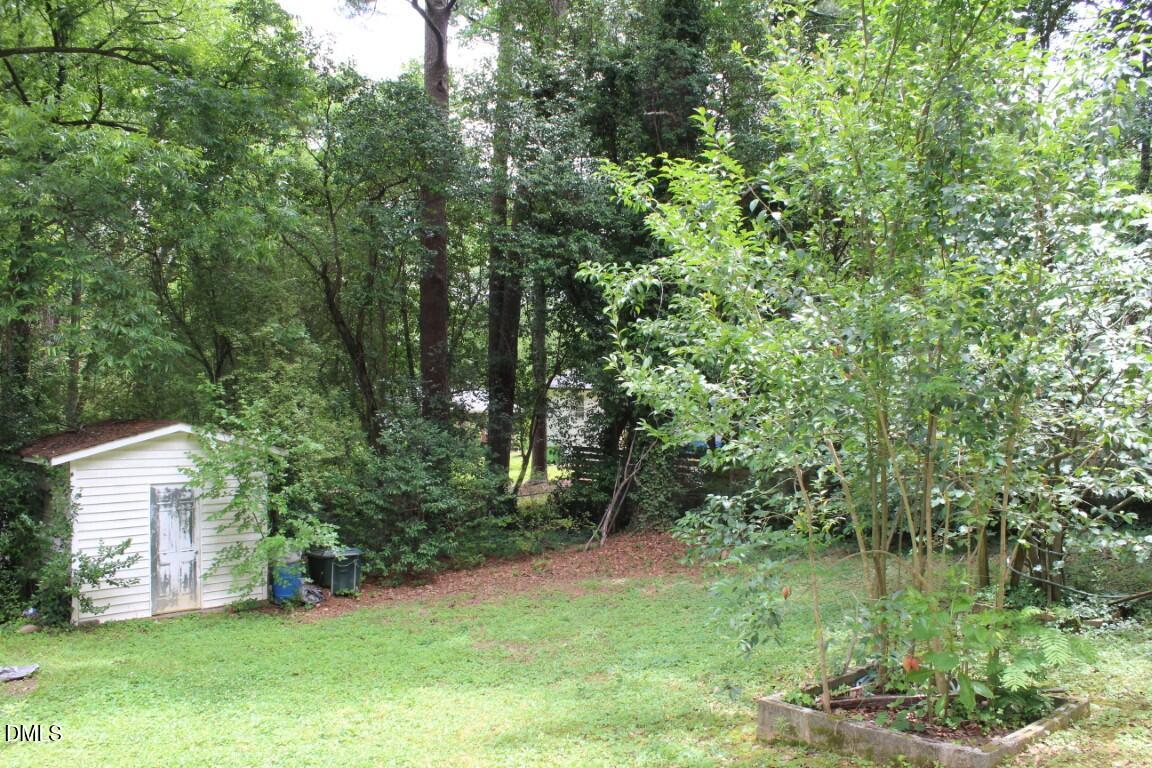 5109 Kaplan Drive Raleigh, NC 27606 - Photo 13 of 13 a backyard of a house with lots of green space