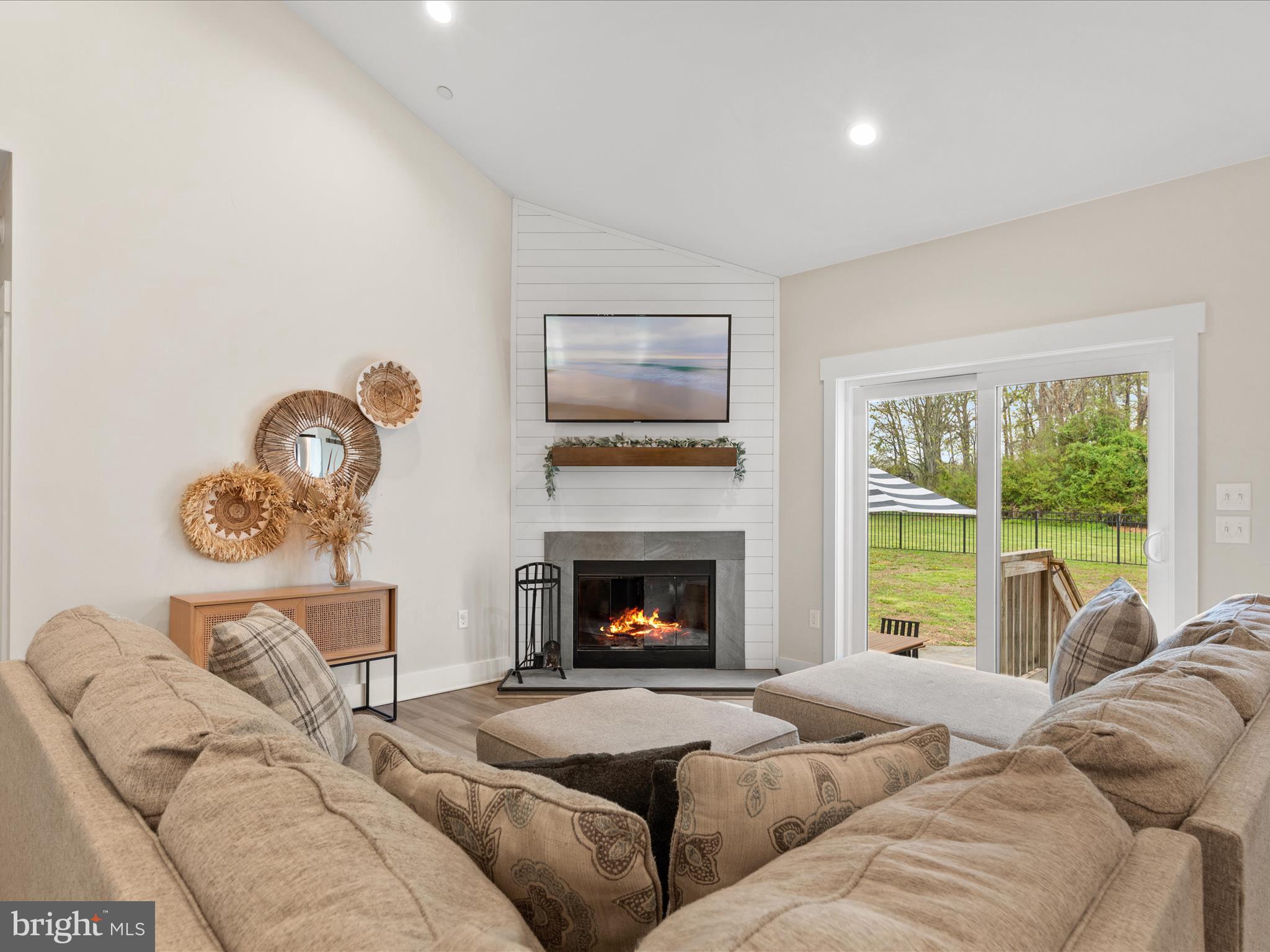 9741 Mason Road Berlin, MD 21811 - Photo 24 of 71 a living room with furniture a fireplace and a large window