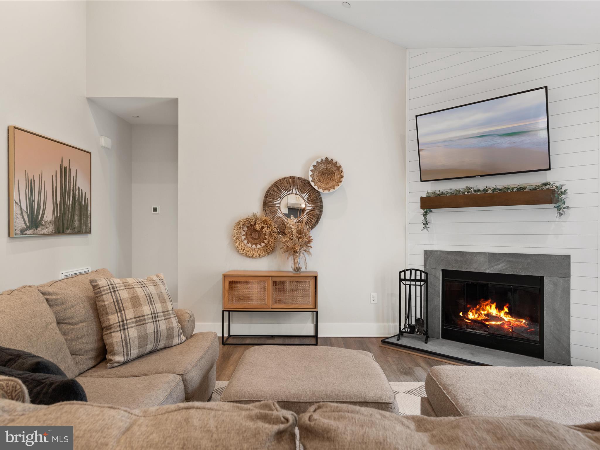 9741 Mason Road Berlin, MD 21811 - Photo 25 of 71 a living room with furniture a flat screen tv and a fireplace
