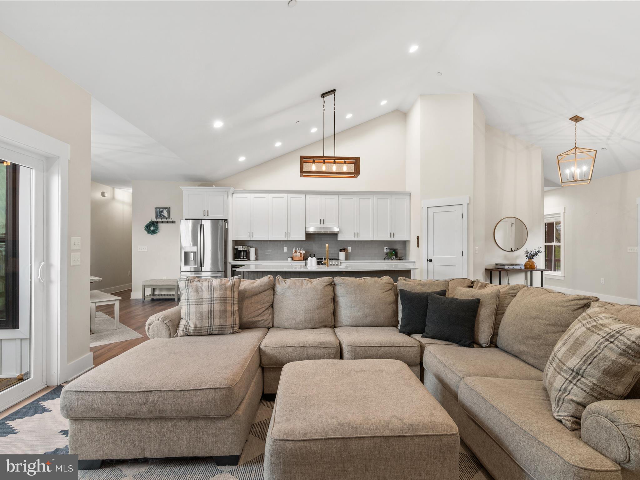 9741 Mason Road Berlin, MD 21811 - Photo 27 of 71 a living room with furniture kitchen view and a chandelier
