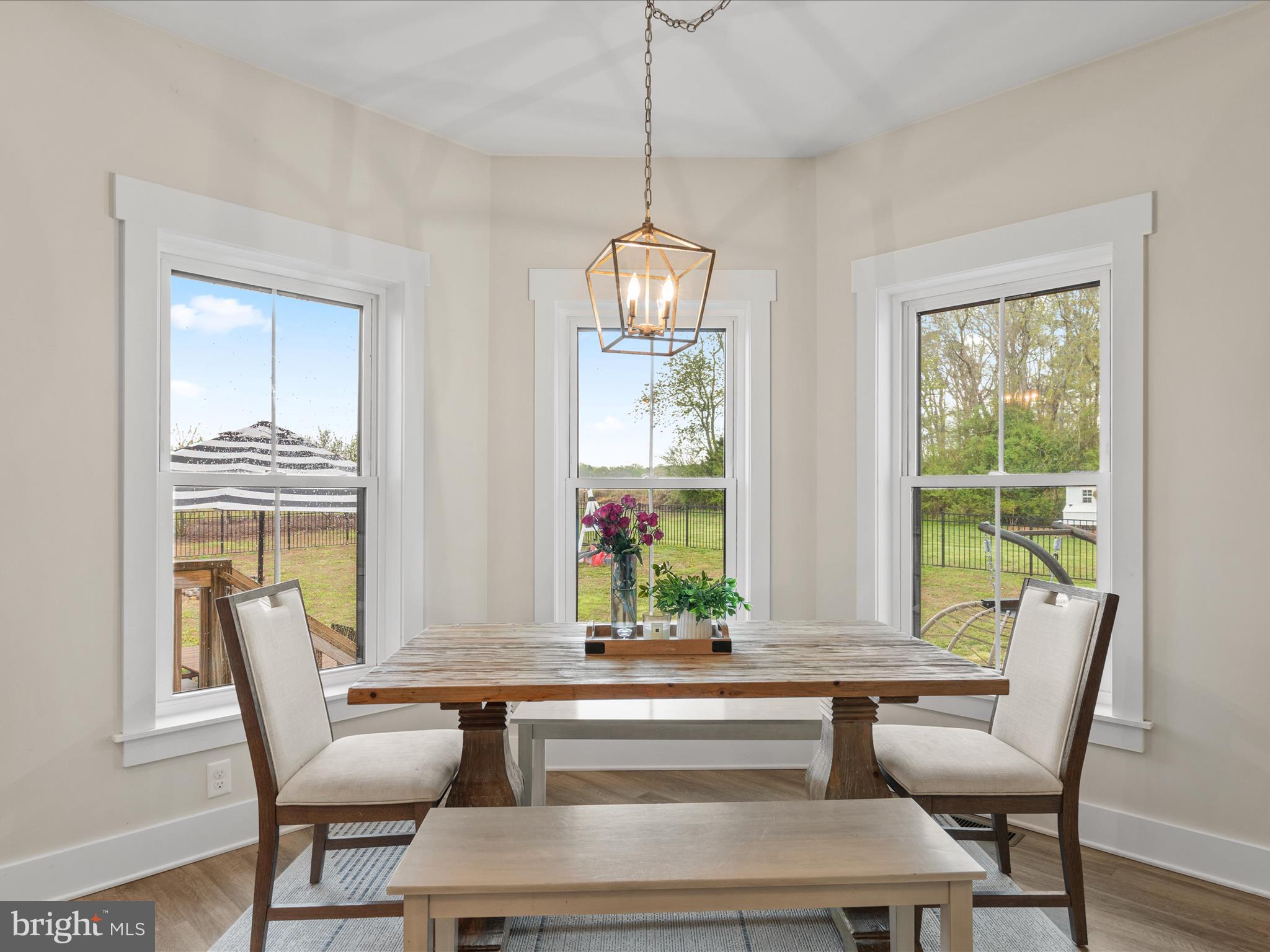 9741 Mason Road Berlin, MD 21811 - Photo 29 of 71 a dining room with furniture a chandelier and wooden floor