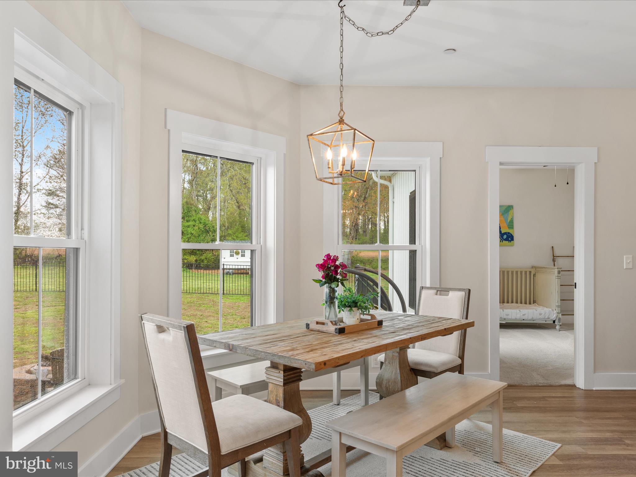 9741 Mason Road Berlin, MD 21811 - Photo 31 of 71 a dining room with furniture a chandelier and wooden floor