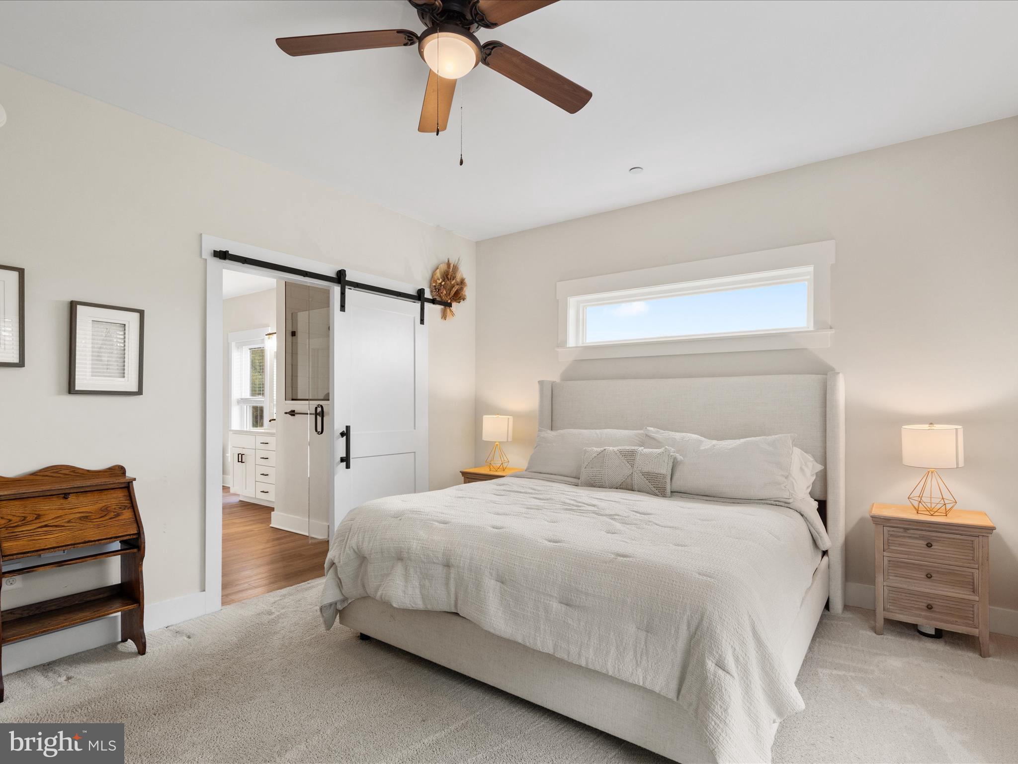9741 Mason Road Berlin, MD 21811 - Photo 33 of 71 a bedroom with a bed and a chandelier