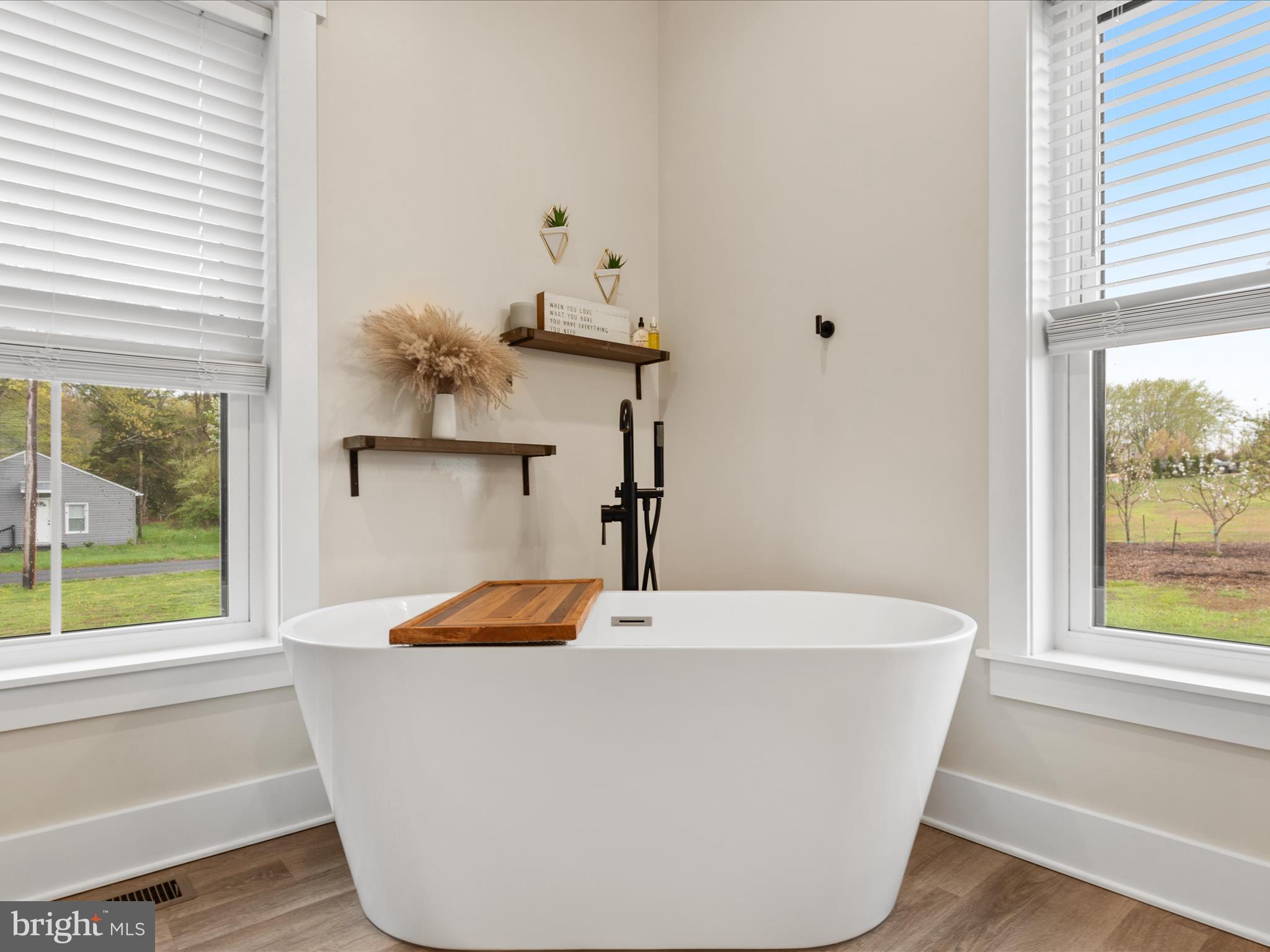 9741 Mason Road Berlin, MD 21811 - Photo 37 of 71 a white bath tub sitting in a bathroom next to a window