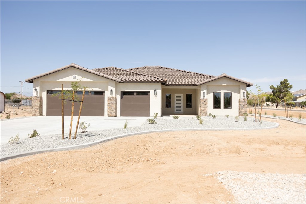 15640 Cheyenne Road Apple Valley, CA 92307 - Photo 1 of 1 a front view of a house with a yard