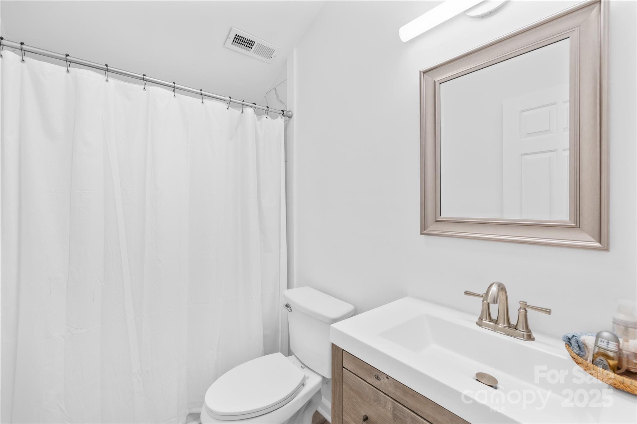 221 Reliance Road Kings Mountain, NC 28086 - Photo 21 of 26 a bathroom with a sink a toilet and shower curtain