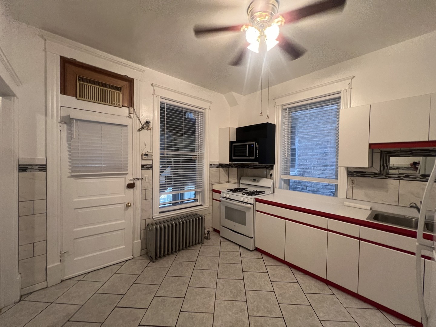 3545 North Sheffield Avenue, Unit 1 Chicago, IL 60657 - Photo 11 of 23 a kitchen with a stove a sink and microwave