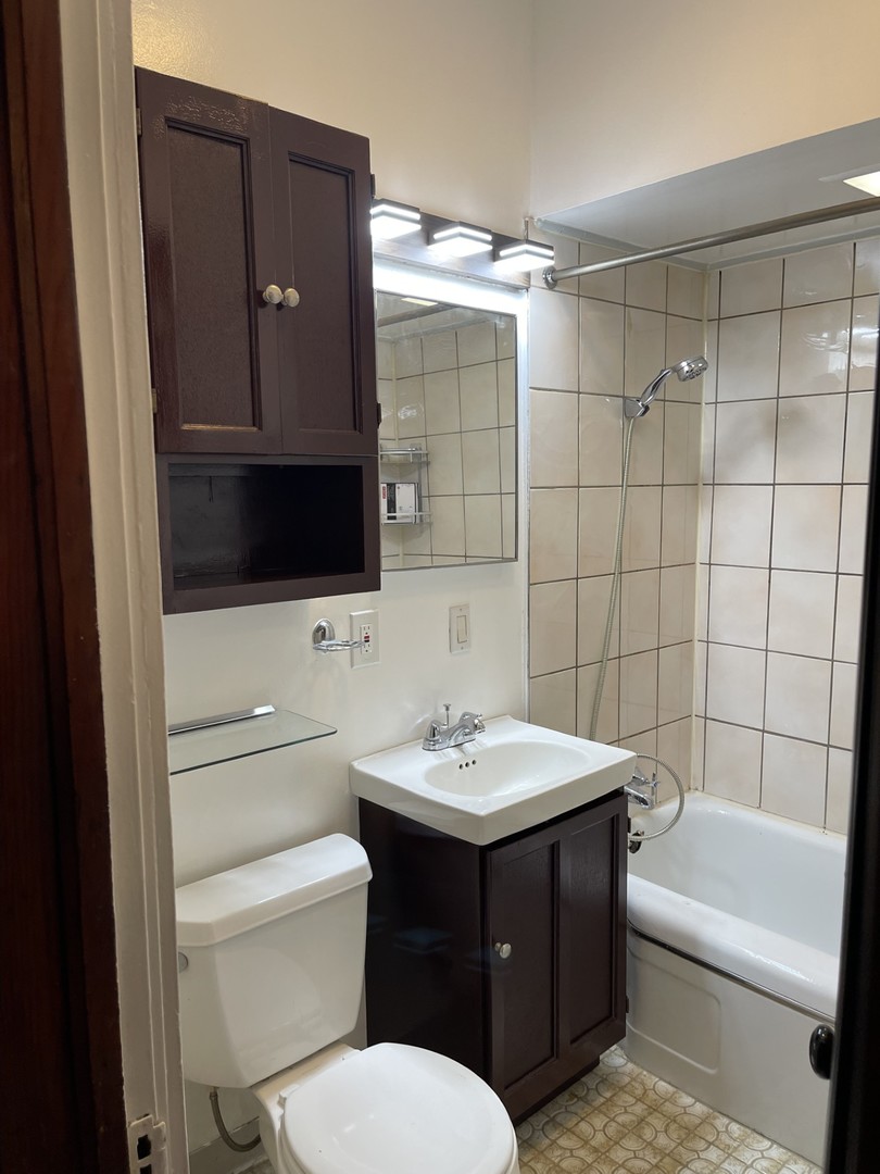 3545 North Sheffield Avenue, Unit 1 Chicago, IL 60657 - Photo 19 of 23 a bathroom with a sink vanity toilet and shower