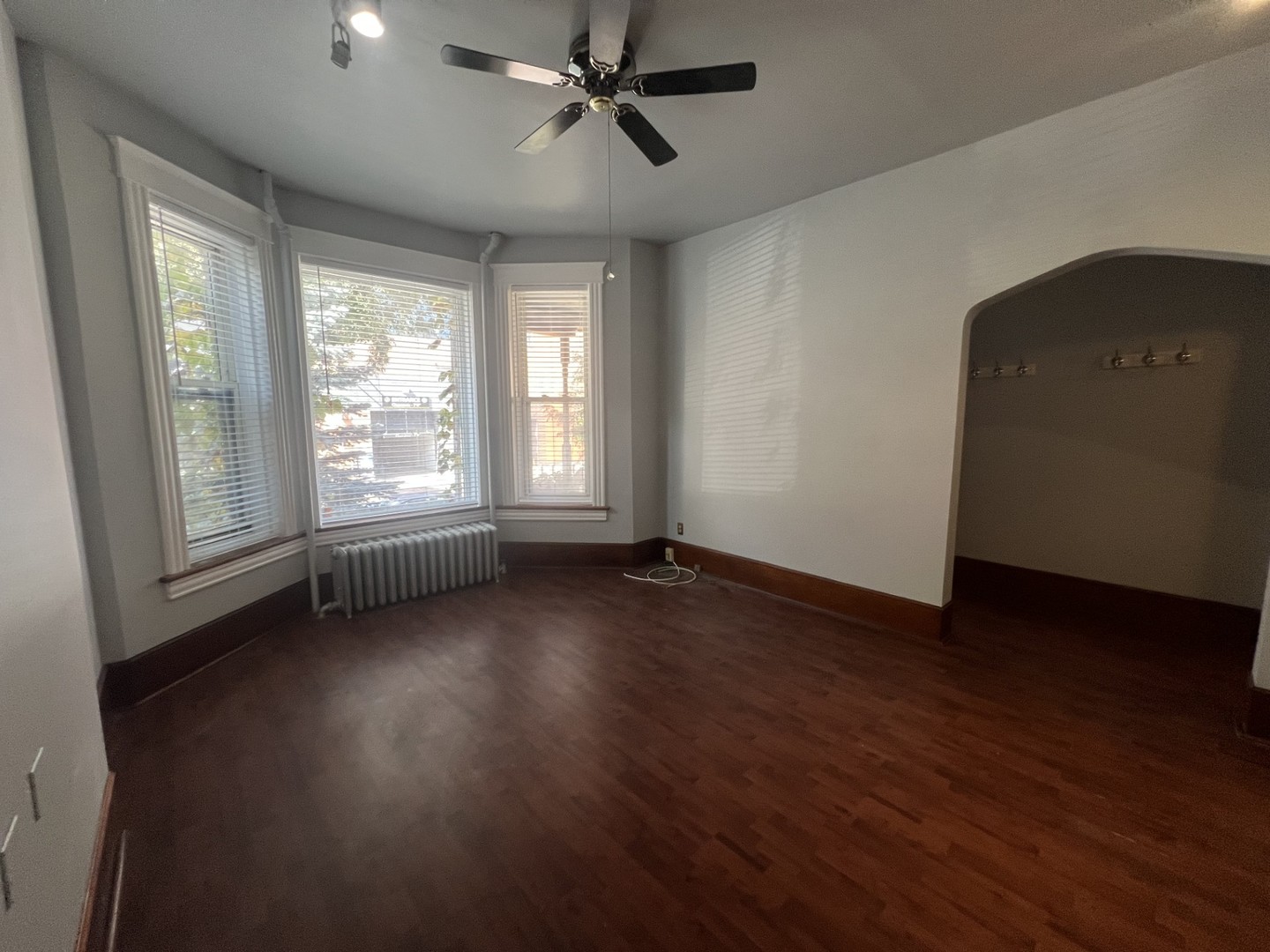 3545 North Sheffield Avenue, Unit 1 Chicago, IL 60657 - Photo 3 of 23 an empty room with wooden floor and windows