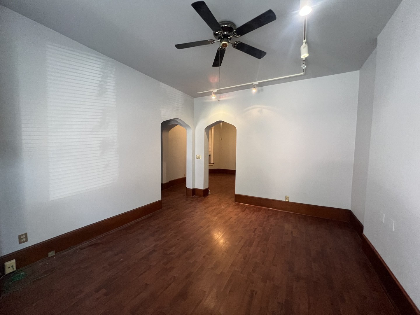 3545 North Sheffield Avenue, Unit 1 Chicago, IL 60657 - Photo 4 of 23 wooden floor in an empty room with a window