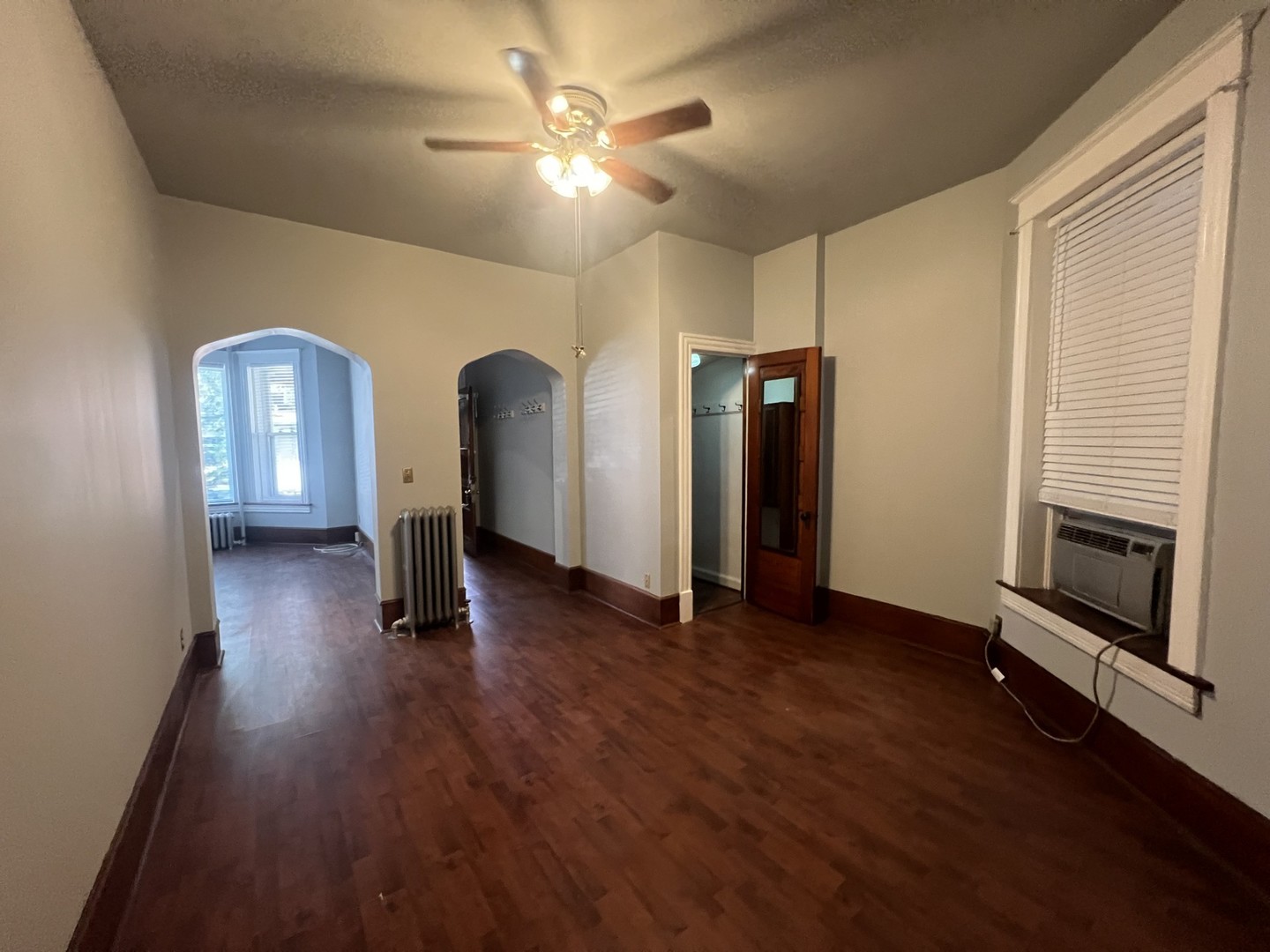 3545 North Sheffield Avenue, Unit 1 Chicago, IL 60657 - Photo 7 of 23 a view of a livingroom with wooden floor and a ceiling fan