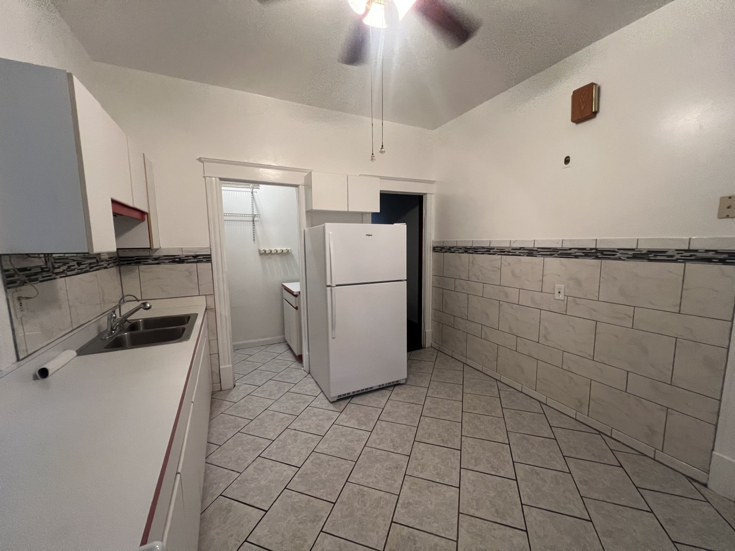 3545 North Sheffield Avenue, Unit 1 Chicago, IL 60657 - Photo 9 of 23 a kitchen with a sink a refrigerator and cabinetry
