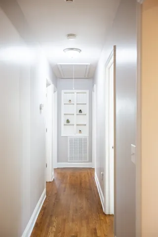 a view of an empty room with wooden floor