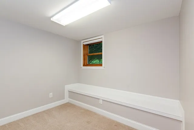 a living room with furniture gym equipment and a fireplace