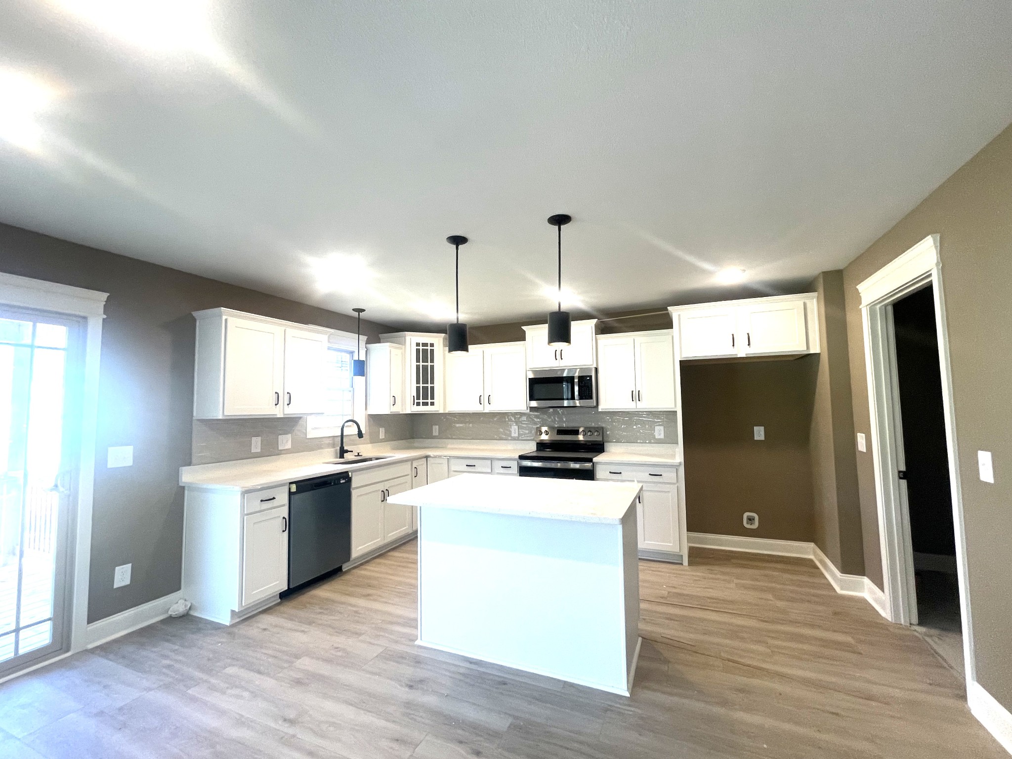 22 Garrettsburg Road Clarksville, TN 37042 - Photo 5 of 21 a kitchen with stainless steel appliances a stove top oven a sink a refrigerator and white cabinets