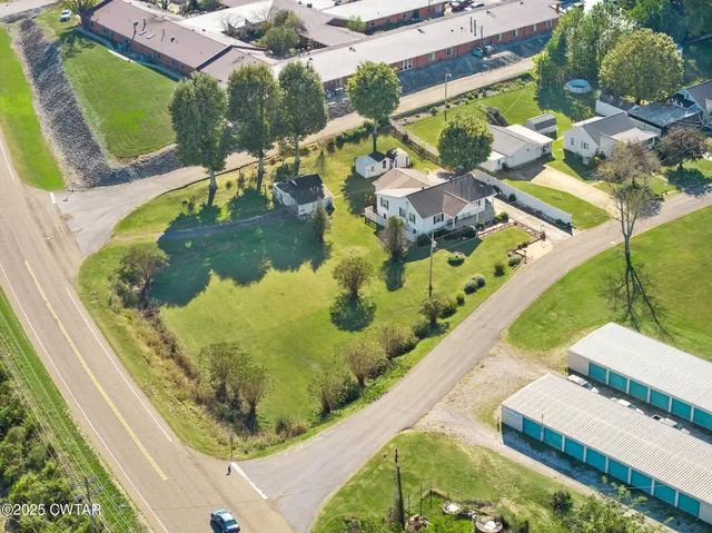 a view of a swimming pool with a yard