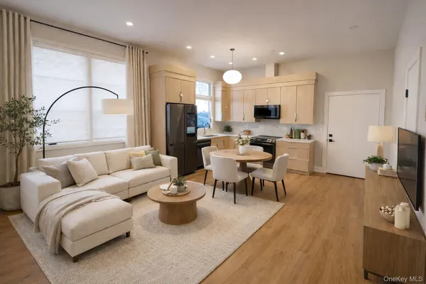 a living room with furniture a flat screen tv and a large window