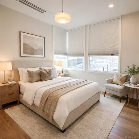 a bedroom with bed and a large window