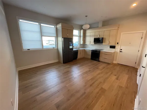 a kitchen with stainless steel appliances a refrigerator sink and microwave