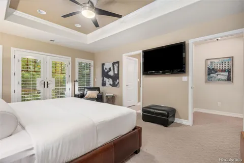 a spacious bathroom with a granite countertop double vanity sink a mirror and a shower