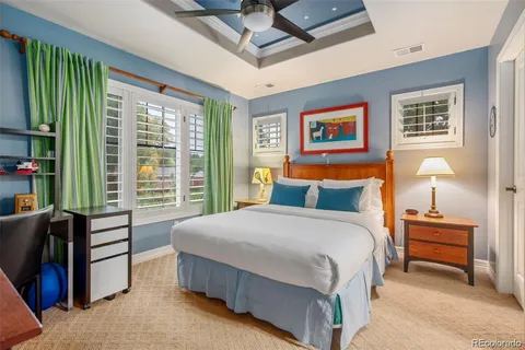 a bedroom with a bed and a book shelf